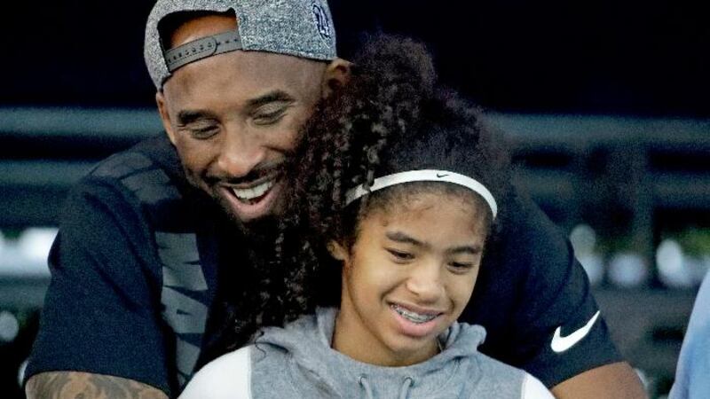 FILE - In this July 26, 2018, file photo, former Los Angeles Laker Kobe Bryant and his...