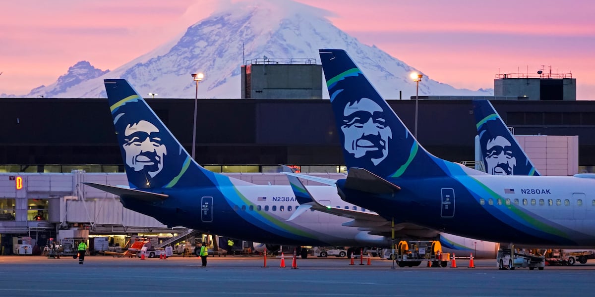 Alaska Airlines passenger opens emergency exit and climbs onto wing of plane, airport says
