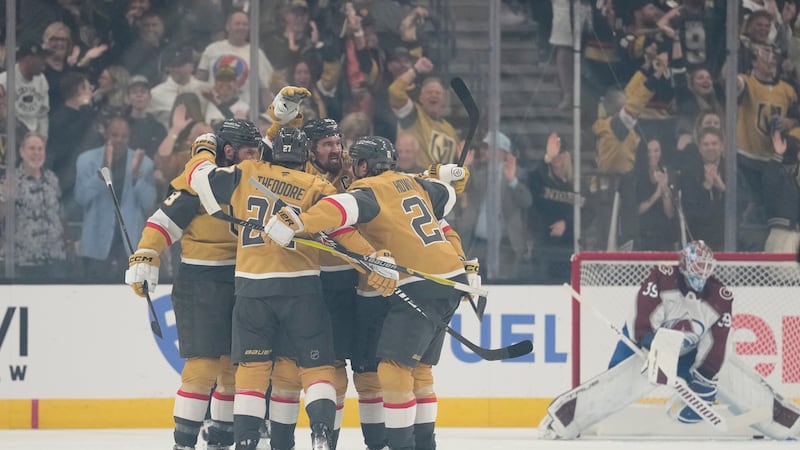 Vegas Golden Knights right wing Mark Stone, back, middle, celebrates with teammates after...
