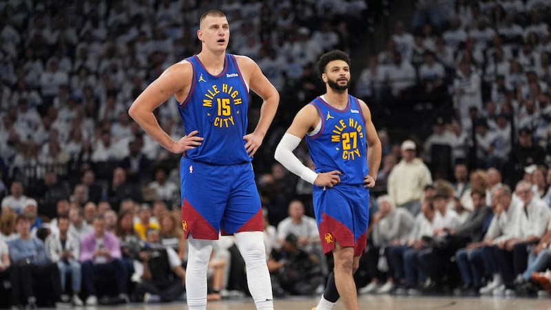 Denver Nuggets center Nikola Jokic (15) and guard Jamal Murray (27) stand on the court during...