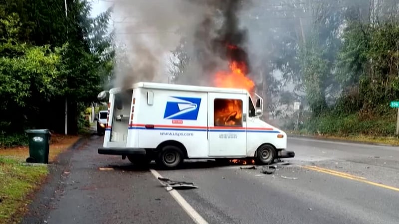 Video shows a good Samaritan pulling an injured mail carrier from his burning truck.